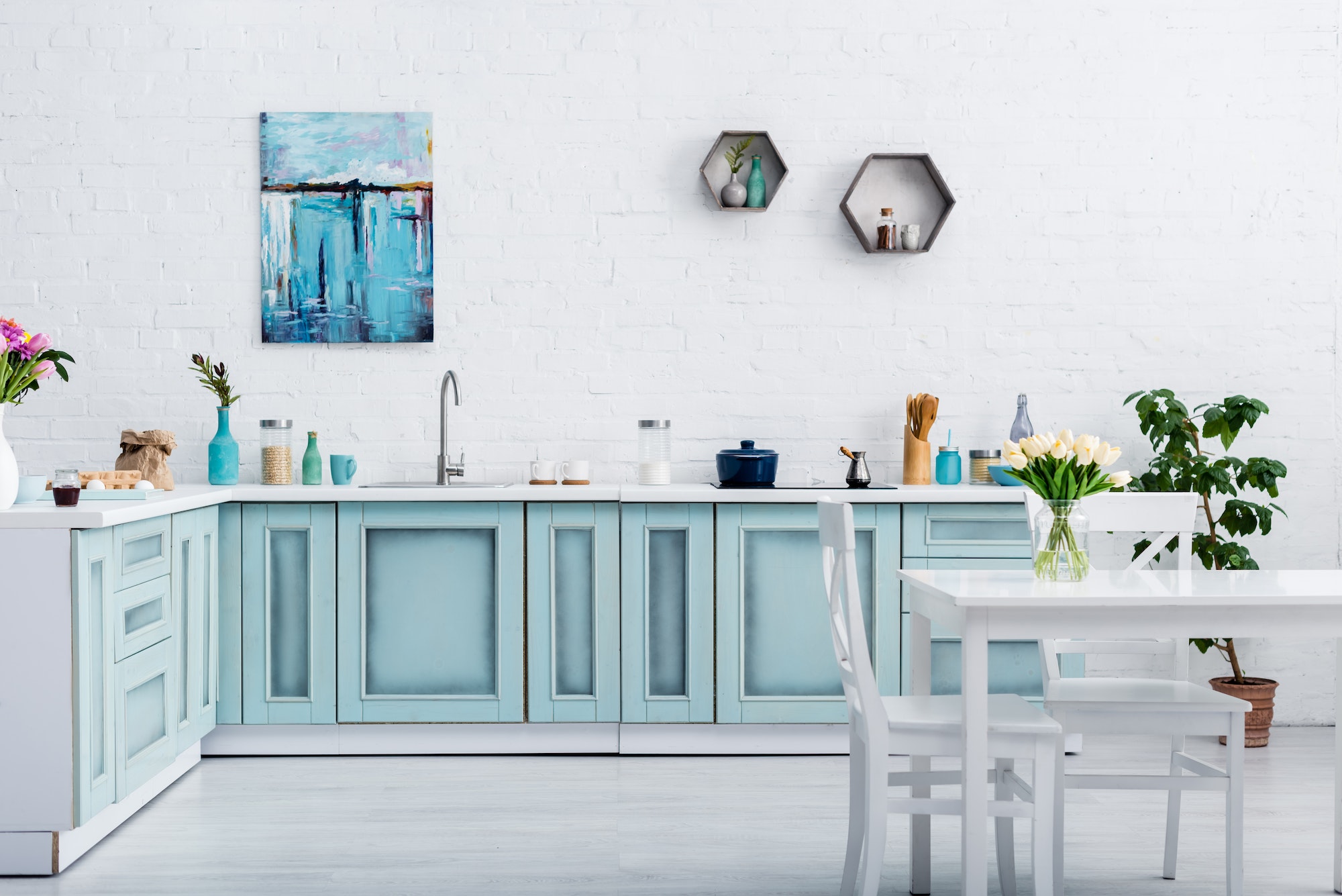 interior of turquoise and white kitchen with kitchenware and decor